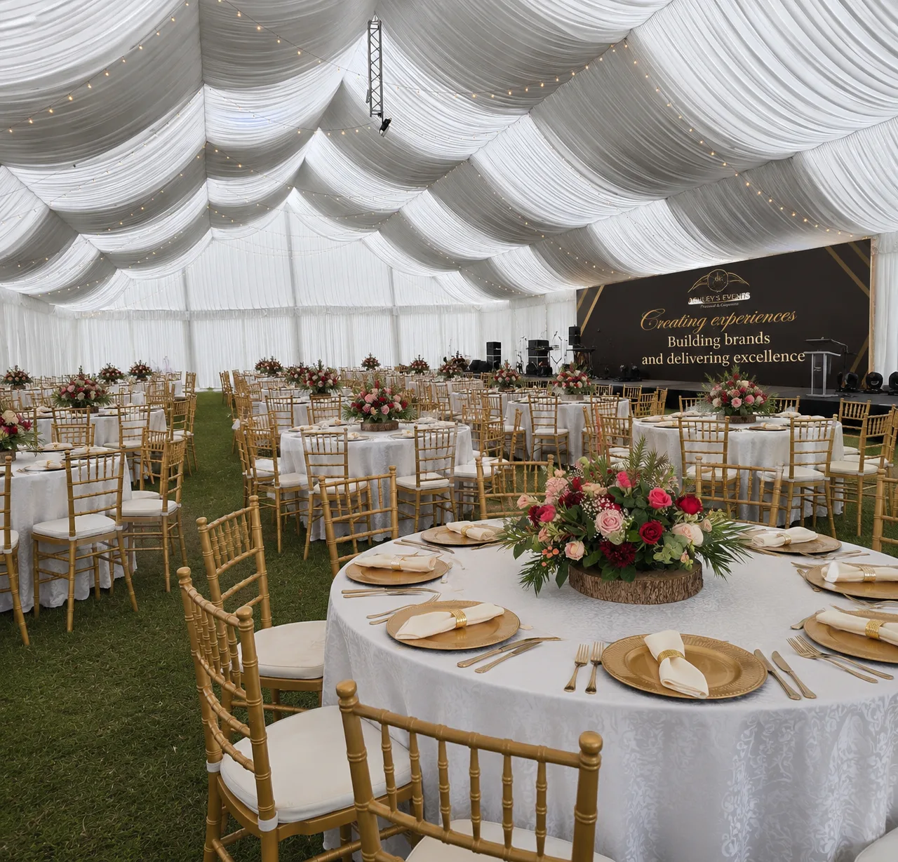 Elegant Ashley’s Events banquet with gold chairs and white ceiling draping